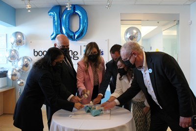 Dr. Madhavi Moharir, Honourable Steven Del Duca, Lara Pietrolungo, Jeff Mainland, Alexandra Ieraci, and Dr. Ronald Cohn in masks celebrating the 10 year anniversary of Boomerang Health.