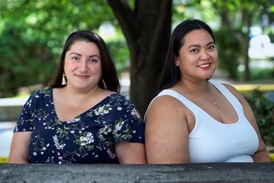 Nursing Practice Council Co-Chairs Sarah Gallie and Kathryn Miller stand in front of a tree smiling at the camera. 