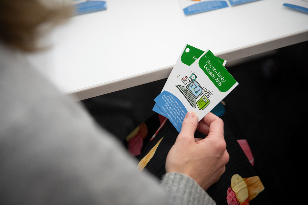 A close up of two cards that are held in a person's hand.