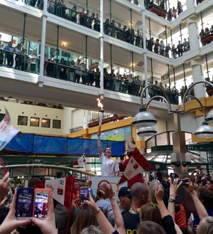 Large crows gather on the main floor and balconies of the SickKids atrium