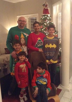 Family wear matching Christmas themed clothes.