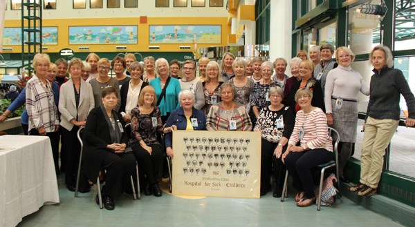 Group of more than 20 women posed for a group photo.