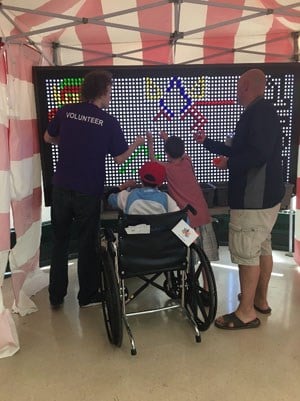 People create a Canada flag with lite brite (small lightbulbs on a board).