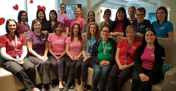 About 20 staff wearing brightly coloured t-shirts.