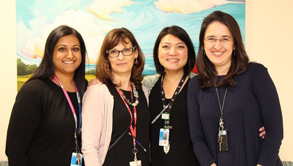 Four women pose side by side.