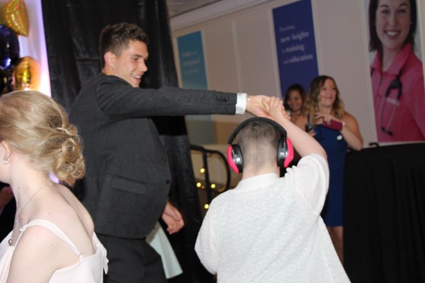 Young man dances with girl.