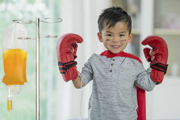 Plasma stand next to boy with boxing gloves on his hands