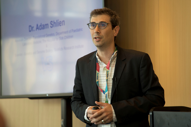 Man stands in front of a screen.