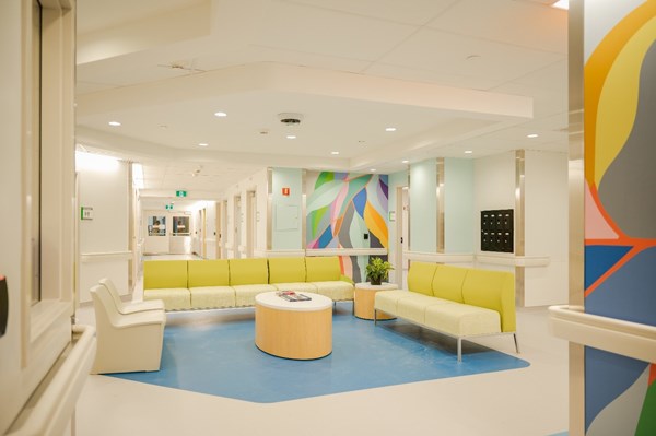 Bright and open waiting room with couches.