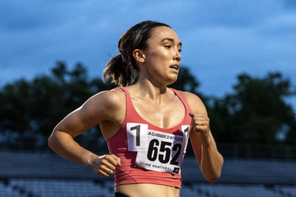 A woman runs, wearing a number on her chest.