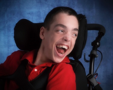 Smiling youth in a wheelchair.