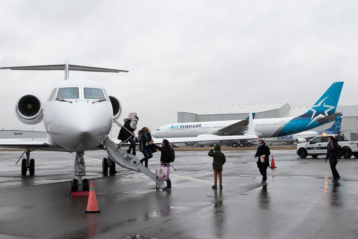 People walking off plane