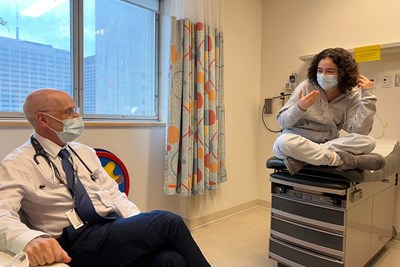 Dr. David Malkin sits in a hospital room with Juliet Locke.