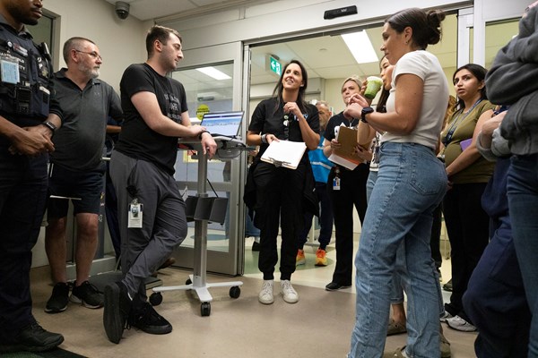 Dr. Natasha Collia, trauma education and simulation lead briefs team before the simulation.