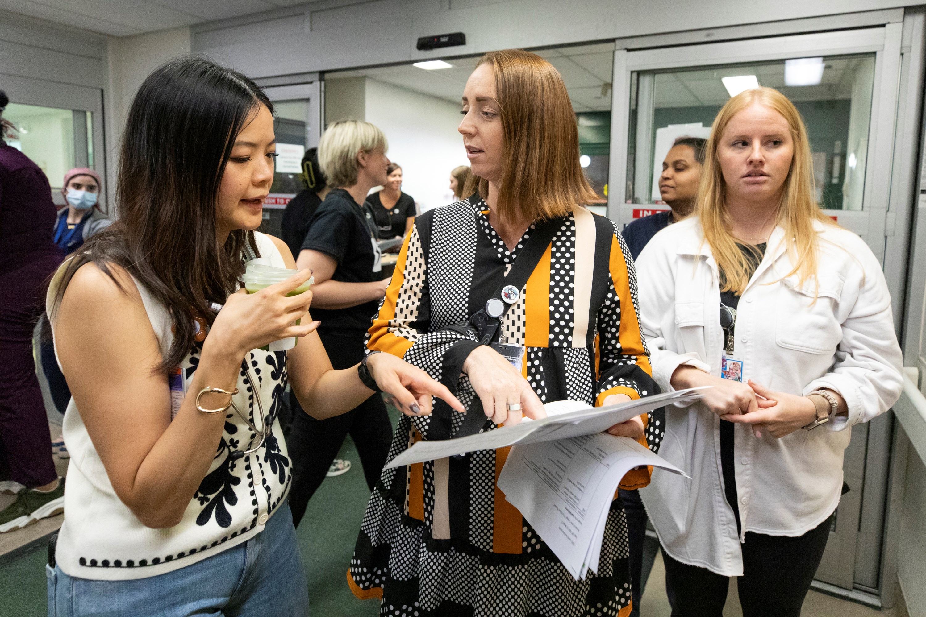Charge nurse Leah McFeeters, centre, speaks to another staff member in front of the ambulance bay before the simulation begins.