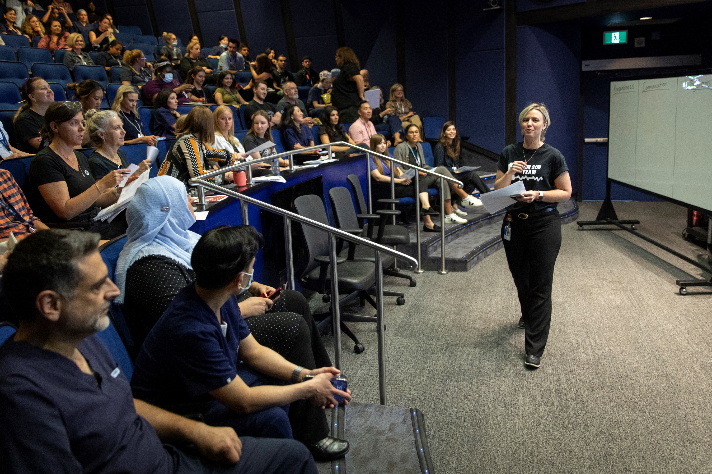 Interprofessional Education Specialist and nurse Seona Dunbar addresses a crowd of participants and facilitators