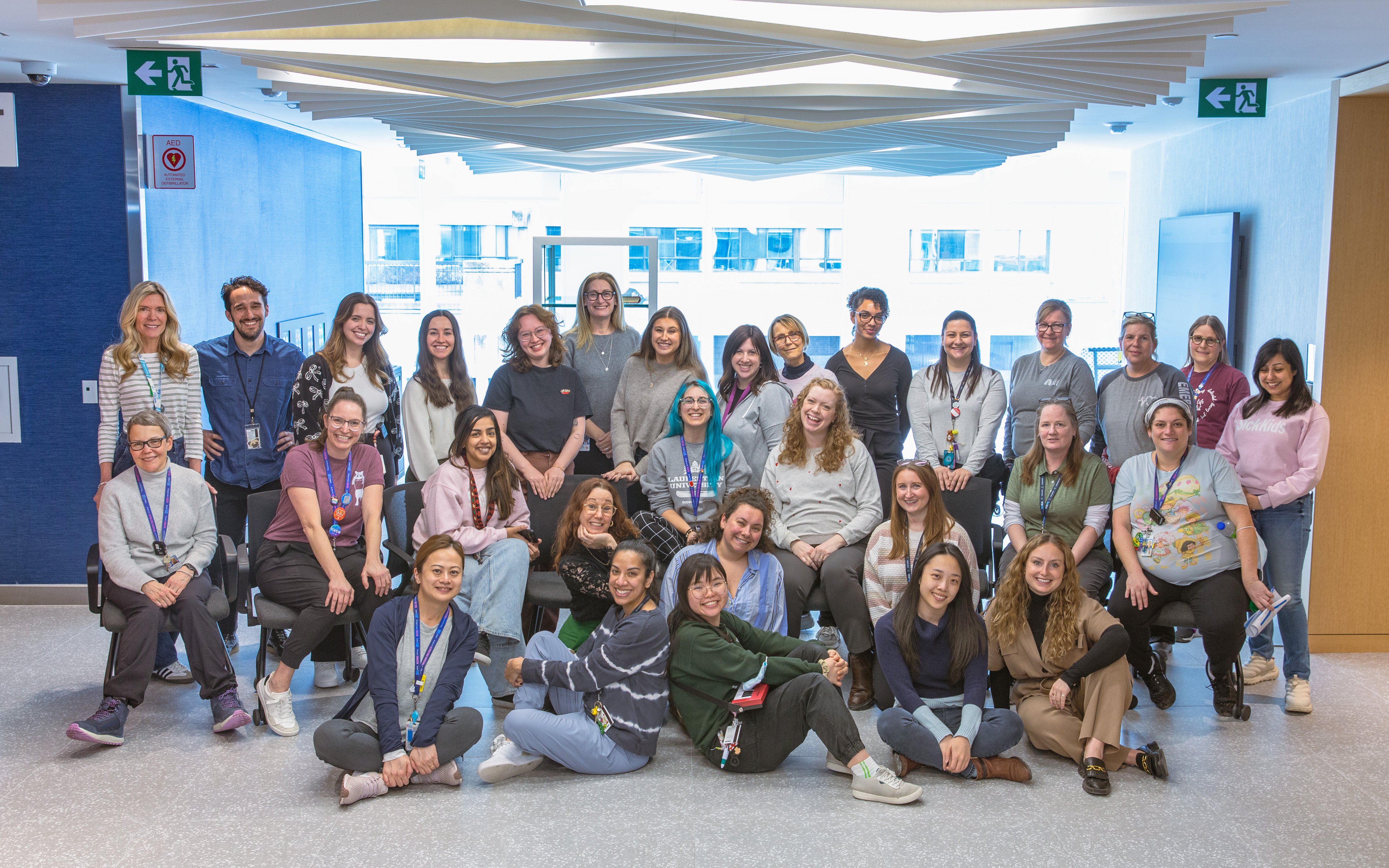 Around 30 members of the Child Life team pose for a group photo.