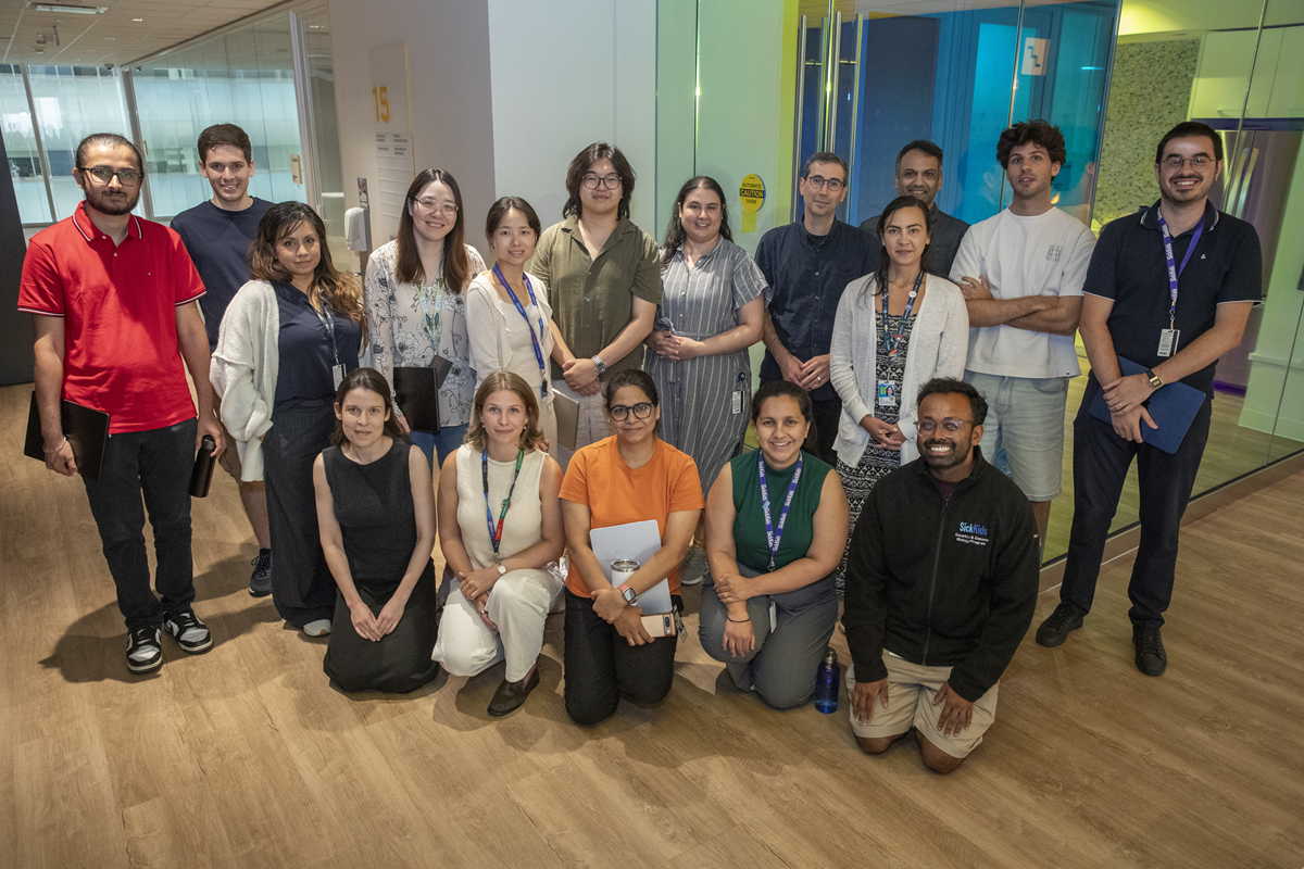 Group of young researchers from the Shlien Lab looking at the camera smiling