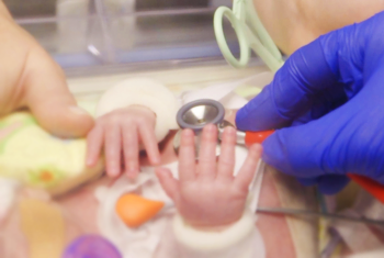 Close up of parent, child and doctor hands during a check-up