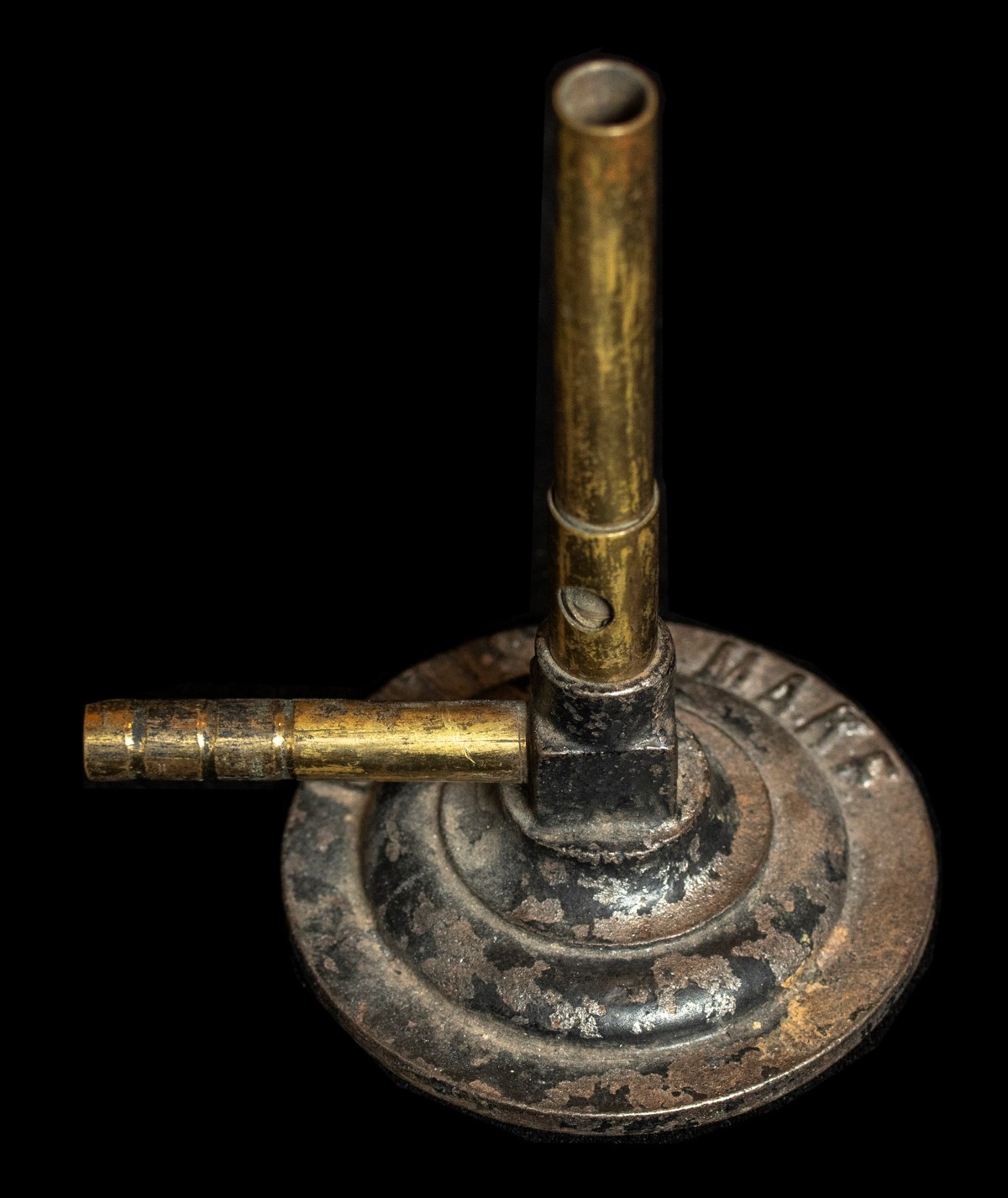 A worn metal Bunsen burner
