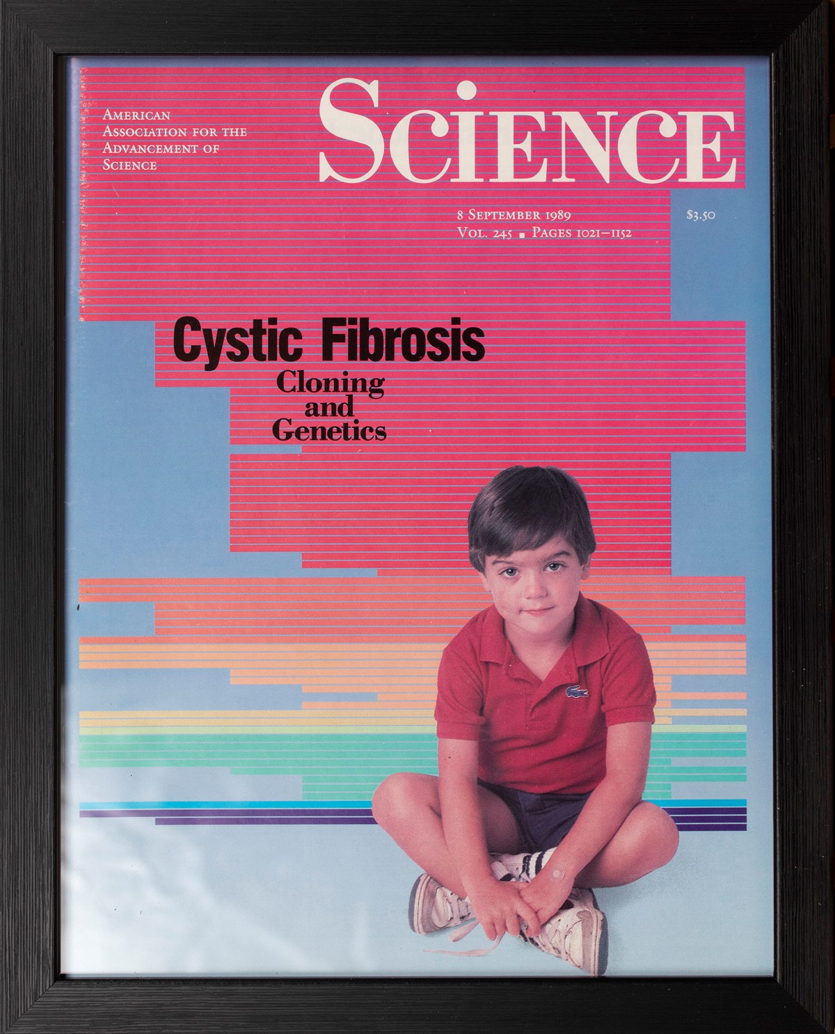 The cover of volume 245 of the journal 'Science'. The cover depicts a child sitting cross-legged in front of a rainbow coloured background. The subtitle reads "Cystic Fibrosis: Cloning and Genetics".
